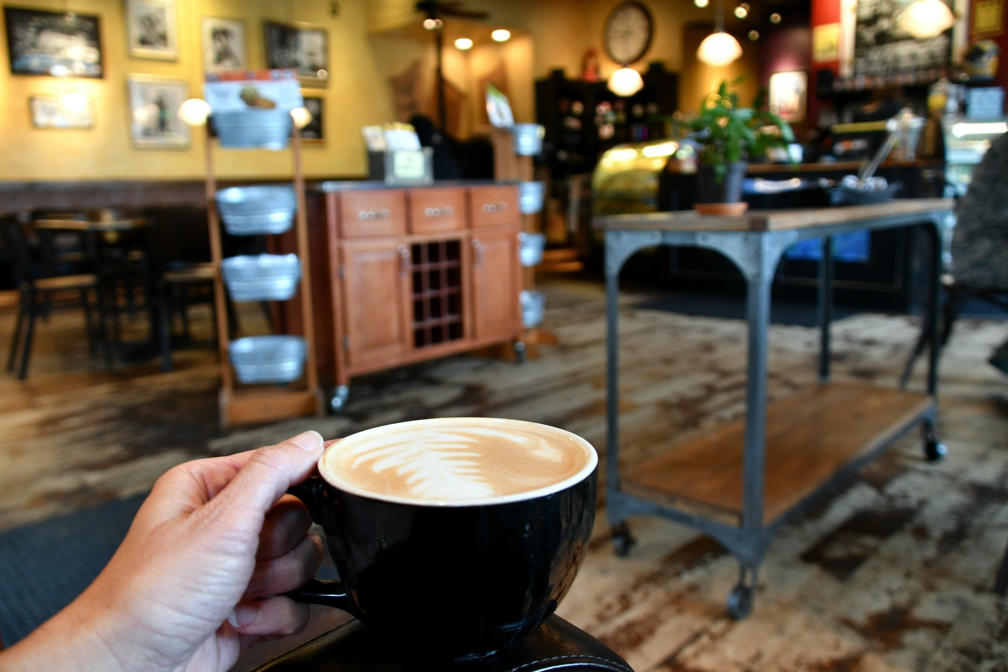 Customer enjoying coffee inside a colorful local small business