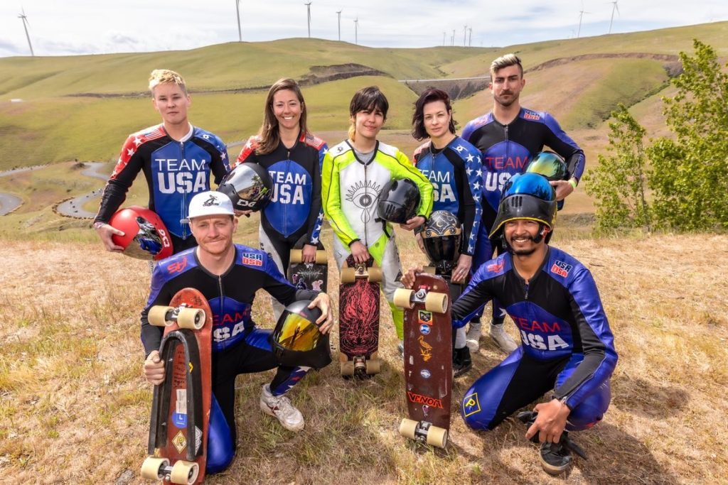 USA downhill skateboarding team members posing outdoors